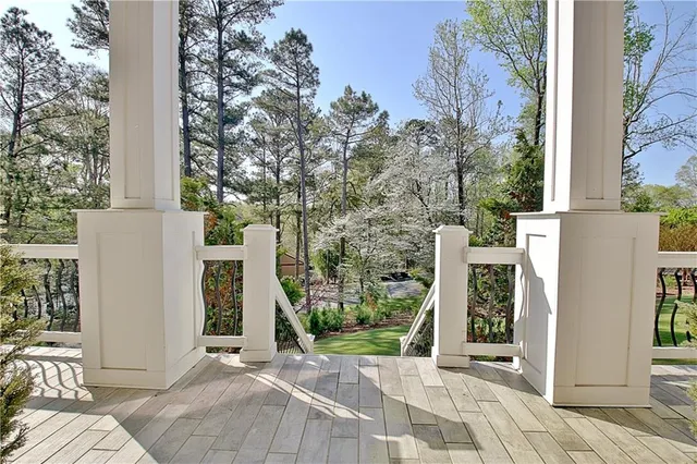 a view of a house with backyard and trees