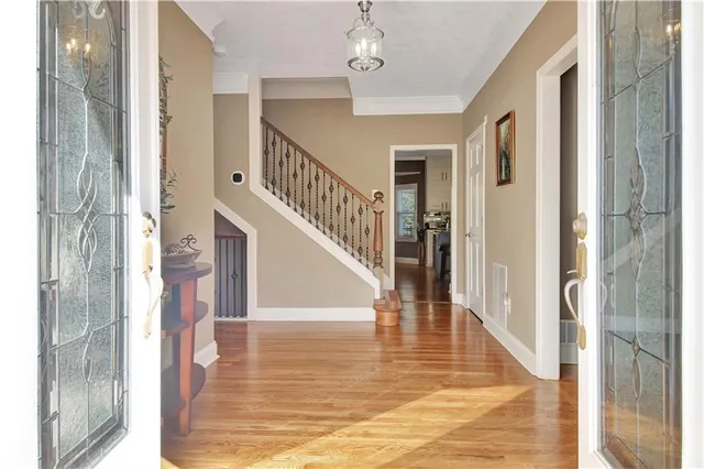 a spacious bedroom with a bed and a large window