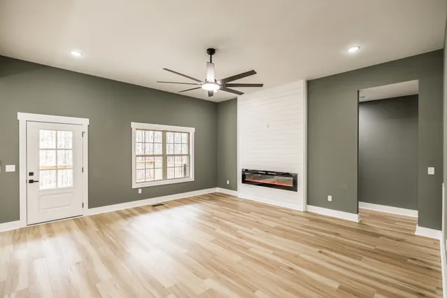 a view of a livingroom with a window and a ceiling fan