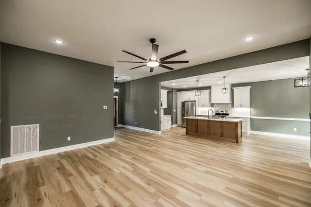 an empty room with fan and a ceiling fan