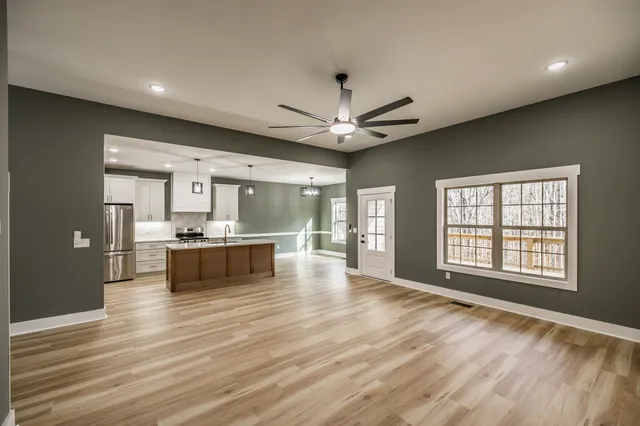 a view of an empty room with a ceiling fan