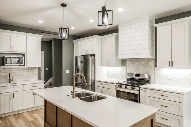 a kitchen with a refrigerator and cabinets