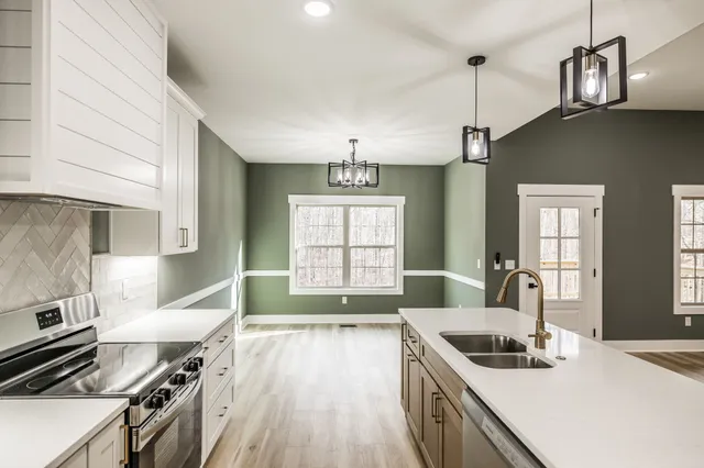 a bathroom with a granite countertop toilet a sink and bathtub