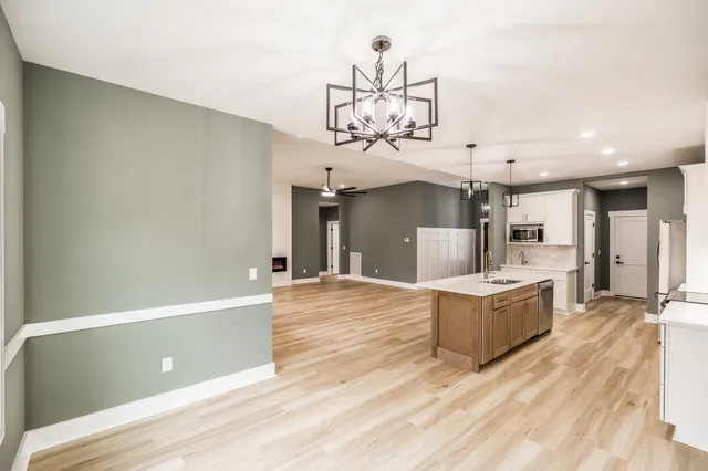 a view of a livingroom with a ceiling fan and wooden floor