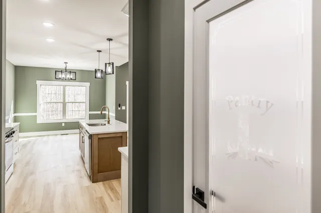 an empty room with closet and windows