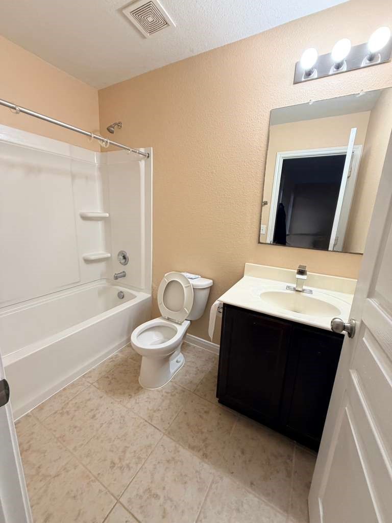 931 Salado Slough Lane Rosenberg, TX 77471 - Photo 6 of 17 a bathroom with a sink vanity mirror and bathtub