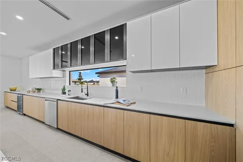 a large kitchen with kitchen island a sink a stove and a center island