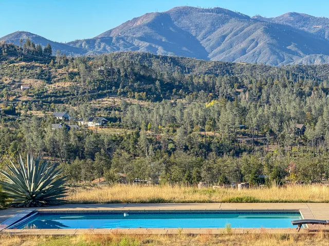 a view of a house with a yard and a mountain view