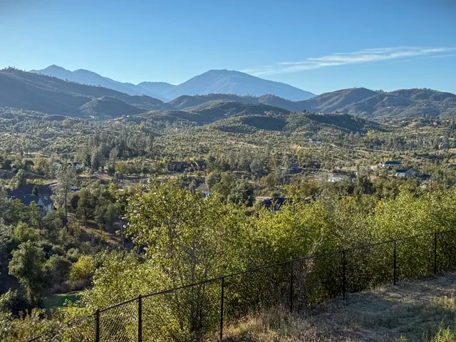 a view of a town with mountains in the background
