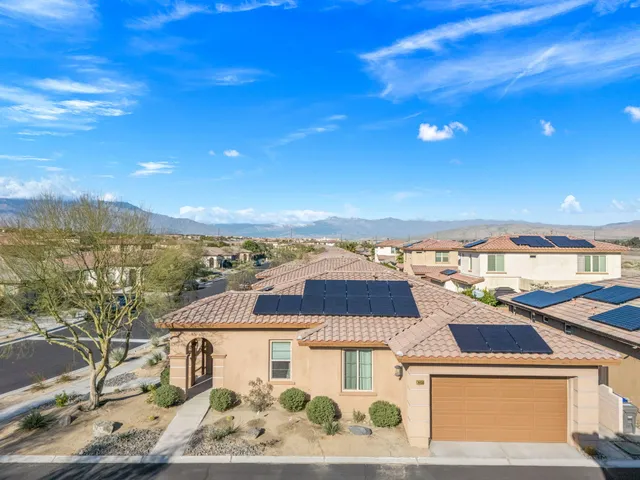 a living room with furniture and a view of kitchen
