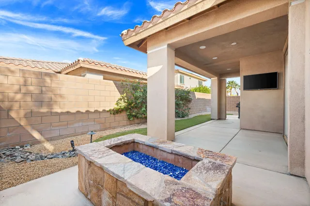 a view of a house with swimming pool and sitting area