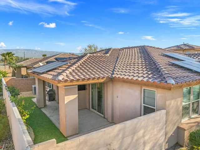 a view of house with swimming pool outdoor seating