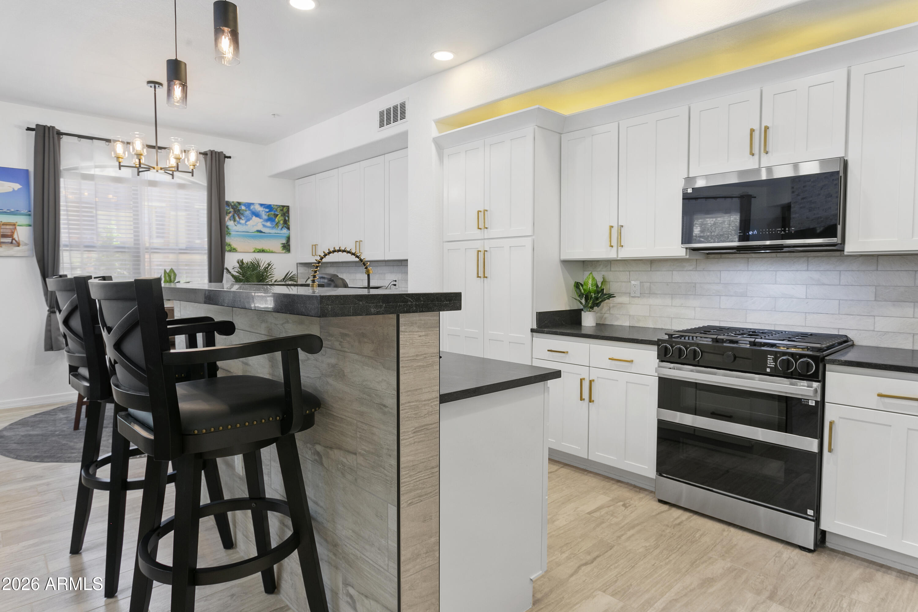 7601 East Indian Bend Road, Unit 1017 Scottsdale, AZ 85250 - Photo 5 of 49 a kitchen with stainless steel appliances kitchen island granite countertop a stove a sink and a refrigerator