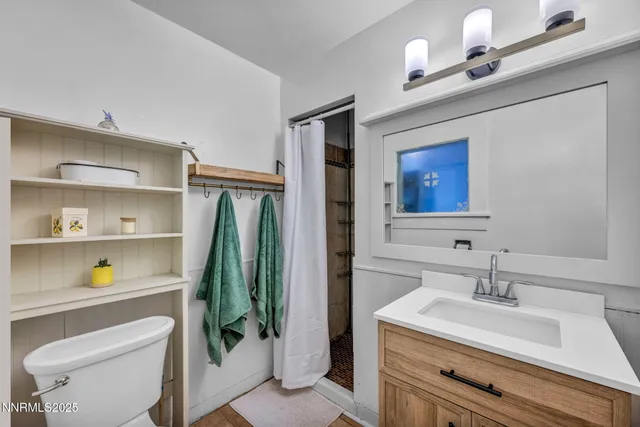 a bathroom with a sink a light fixture and a mirror