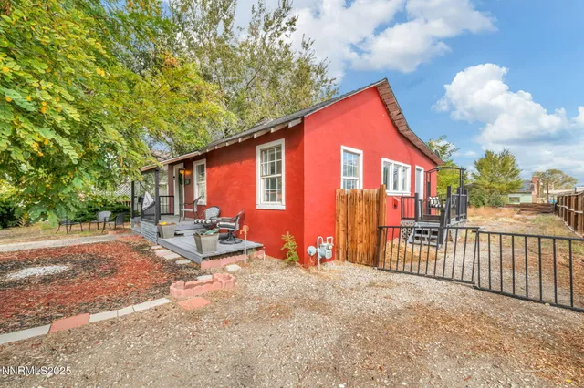 a view of a house with backyard and sitting area