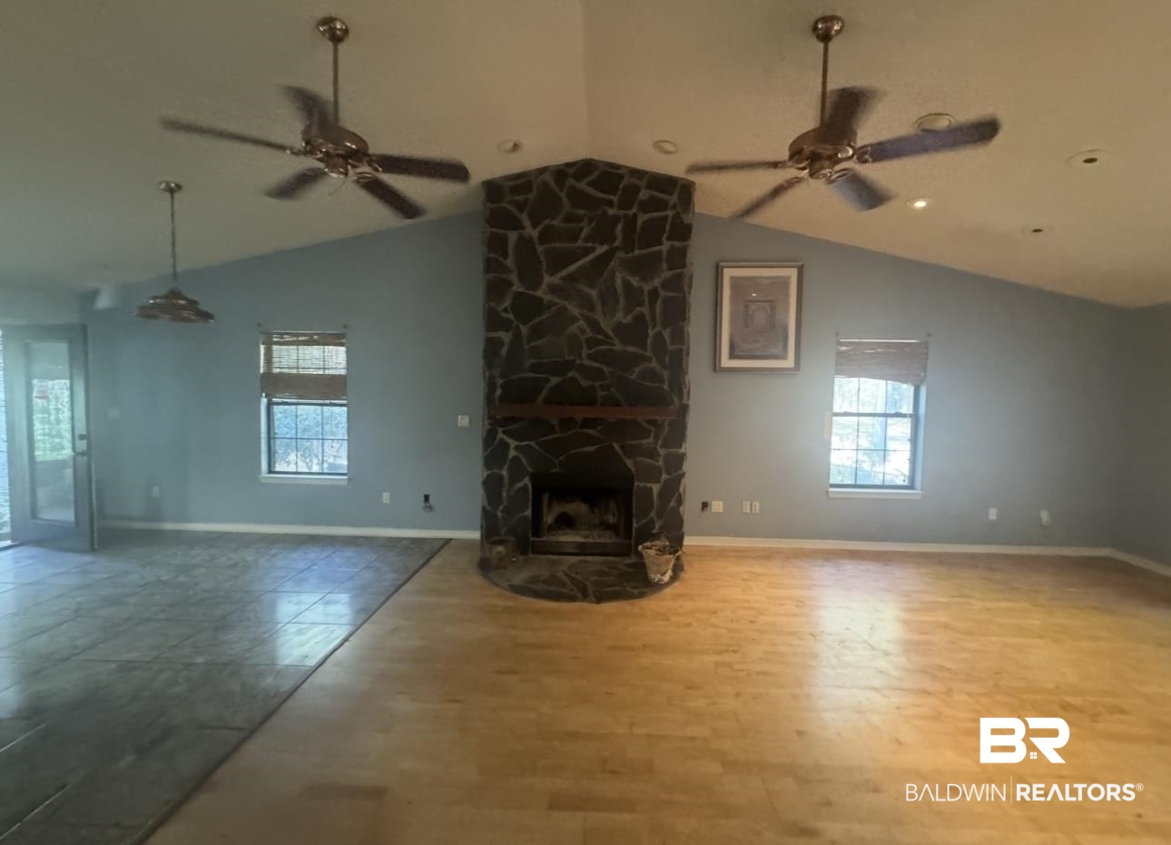 23341 County Road 49 Silverhill, AL 36576 - Photo 6 of 23 Unfurnished living room featuring ceiling fan, vaulted ceiling, a fireplace, and healthy amount of natural light