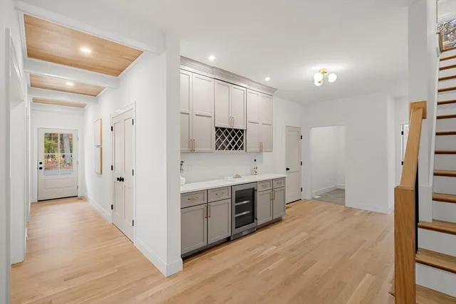 a view of a kitchen with stainless steel appliances a sink and a refrigerator