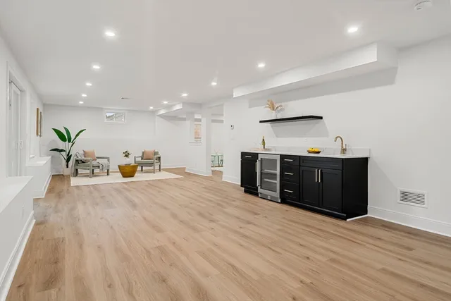 a bathroom with a double vanity sink toilet mirror and shower