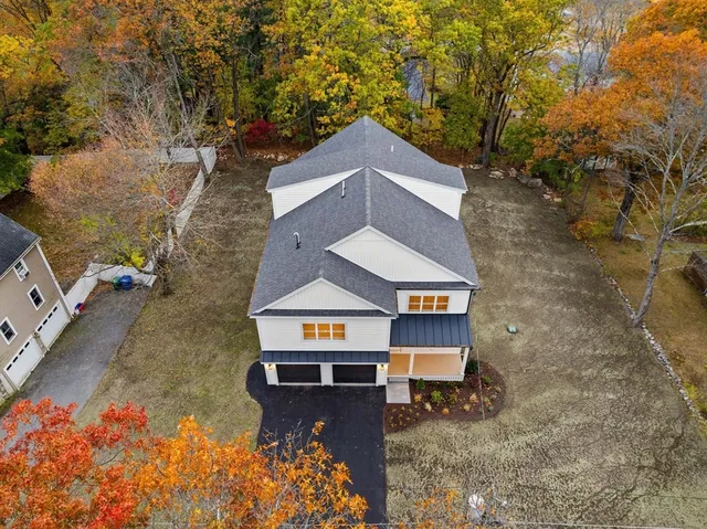 an aerial view of a house with a yard