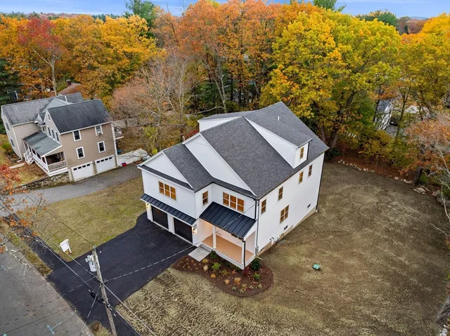 an aerial view of a residential houses with outdoor space