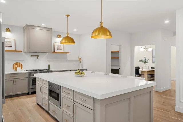 a kitchen with a sink a stove and a wooden floors