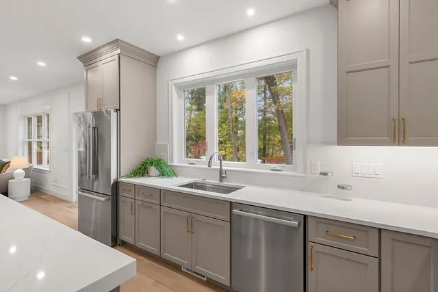 a kitchen with a sink and refrigerator