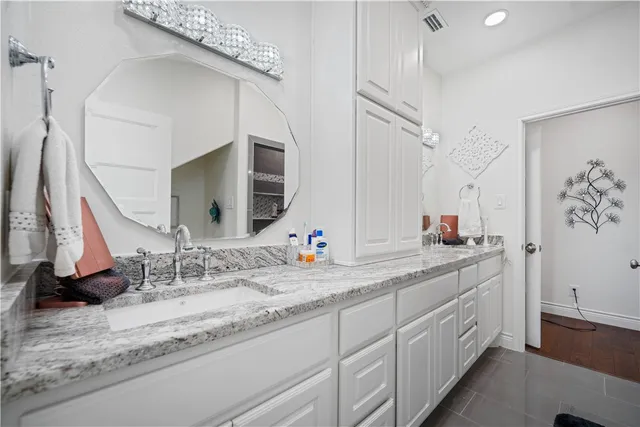 a bathroom with a double vanity sink and a mirror