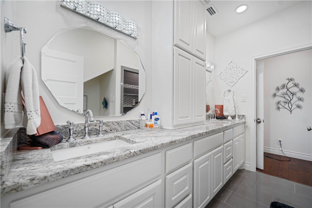 741 County Road 159 Kenedy, TX 78119 - Photo 16 of 37 a bathroom with a double vanity sink and a mirror