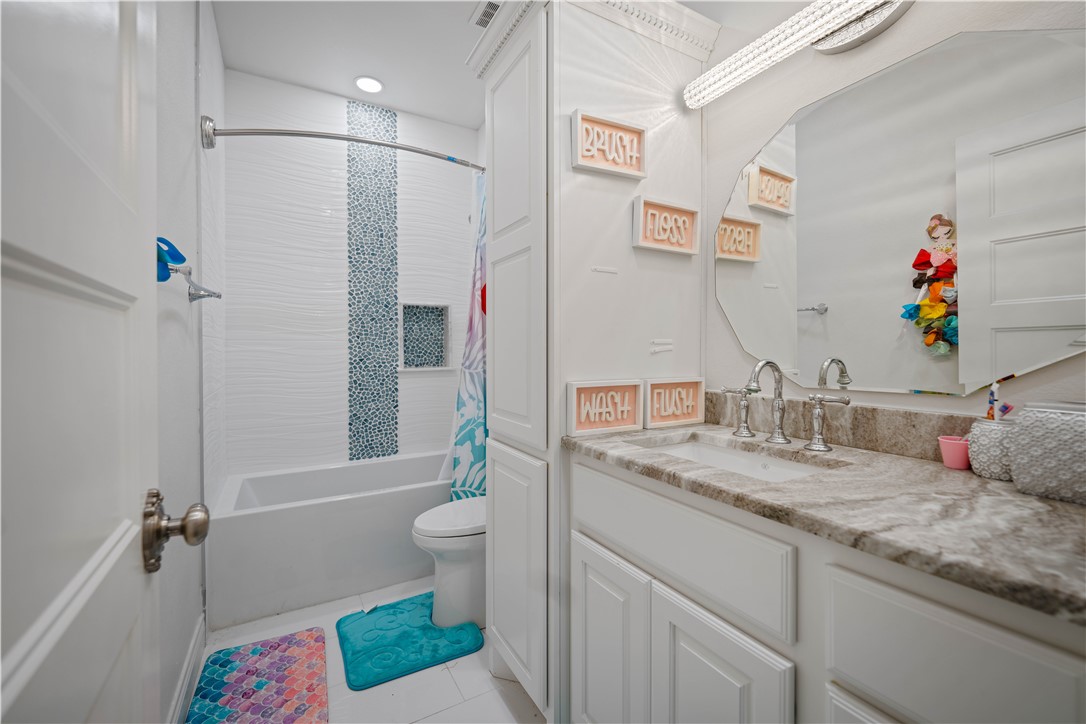 741 County Road 159 Kenedy, TX 78119 - Photo 19 of 37 a bathroom with a granite countertop sink a toilet and shower
