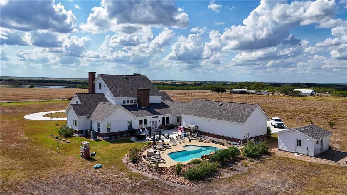 741 County Road 159 Kenedy, TX 78119 - Photo 2 of 37 an aerial view of a house with swimming pool and yard