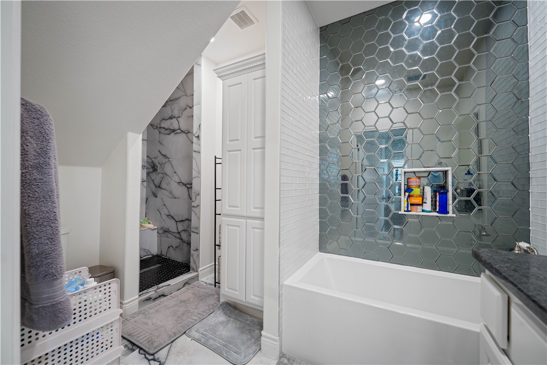 741 County Road 159 Kenedy, TX 78119 - Photo 22 of 37 a bathroom with a bathtub and a shower