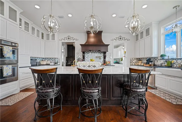 a view of a dining room with furniture a chandelier and wooden floor