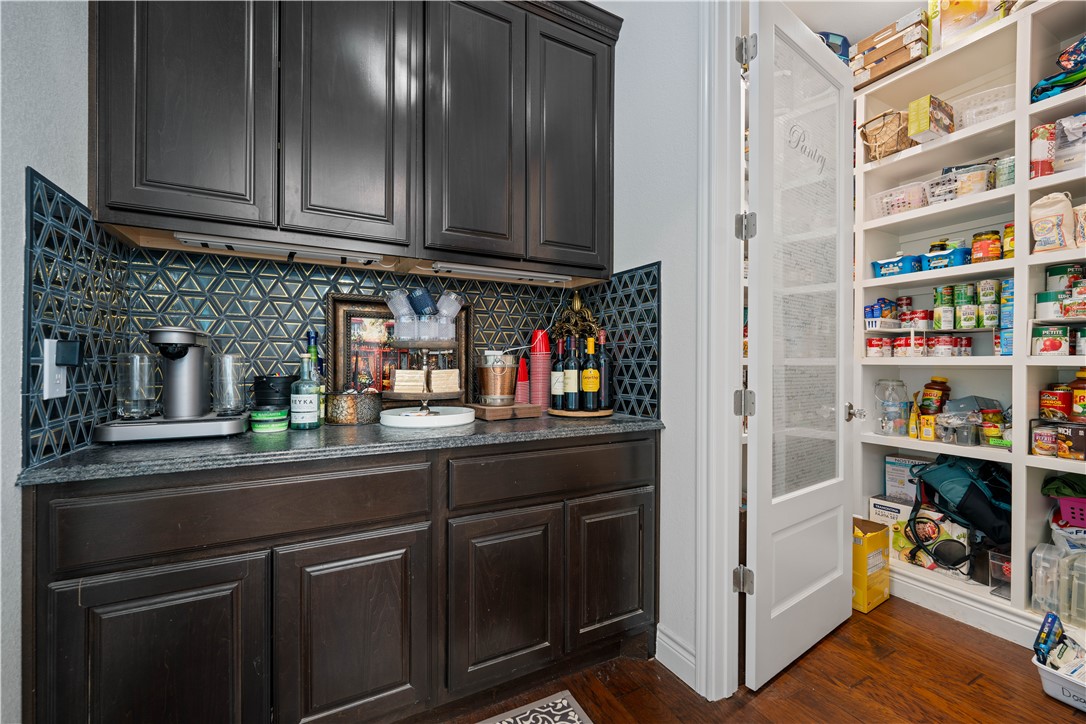 741 County Road 159 Kenedy, TX 78119 - Photo 7 of 37 a kitchen with stainless steel appliances granite countertop a refrigerator and wooden cabinets
