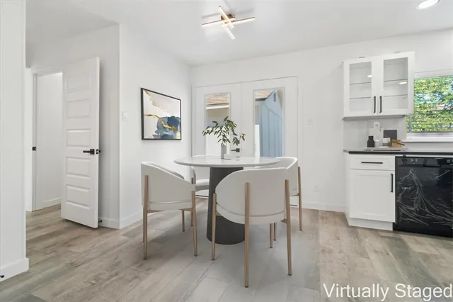 a view of a dining room with furniture and wooden floor