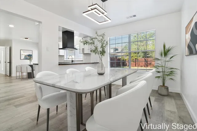 a dining room with furniture and wooden floor