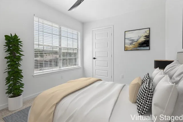 a bedroom with a bed and a window