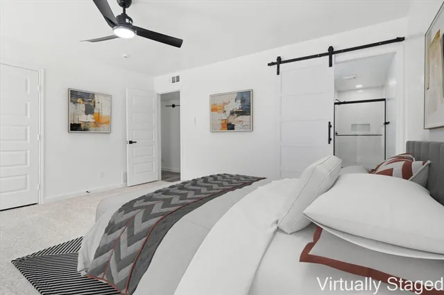 a bedroom with a bed and ceiling fan