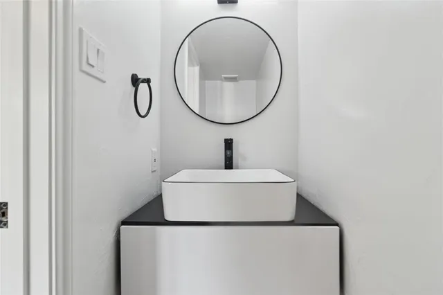 a bathroom with a sink and mirror
