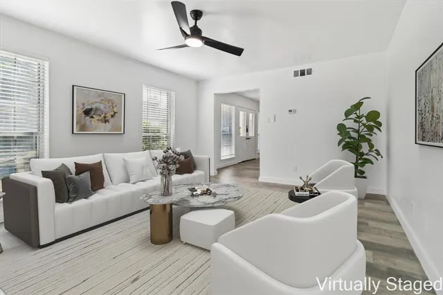 a living room with furniture and wooden floor