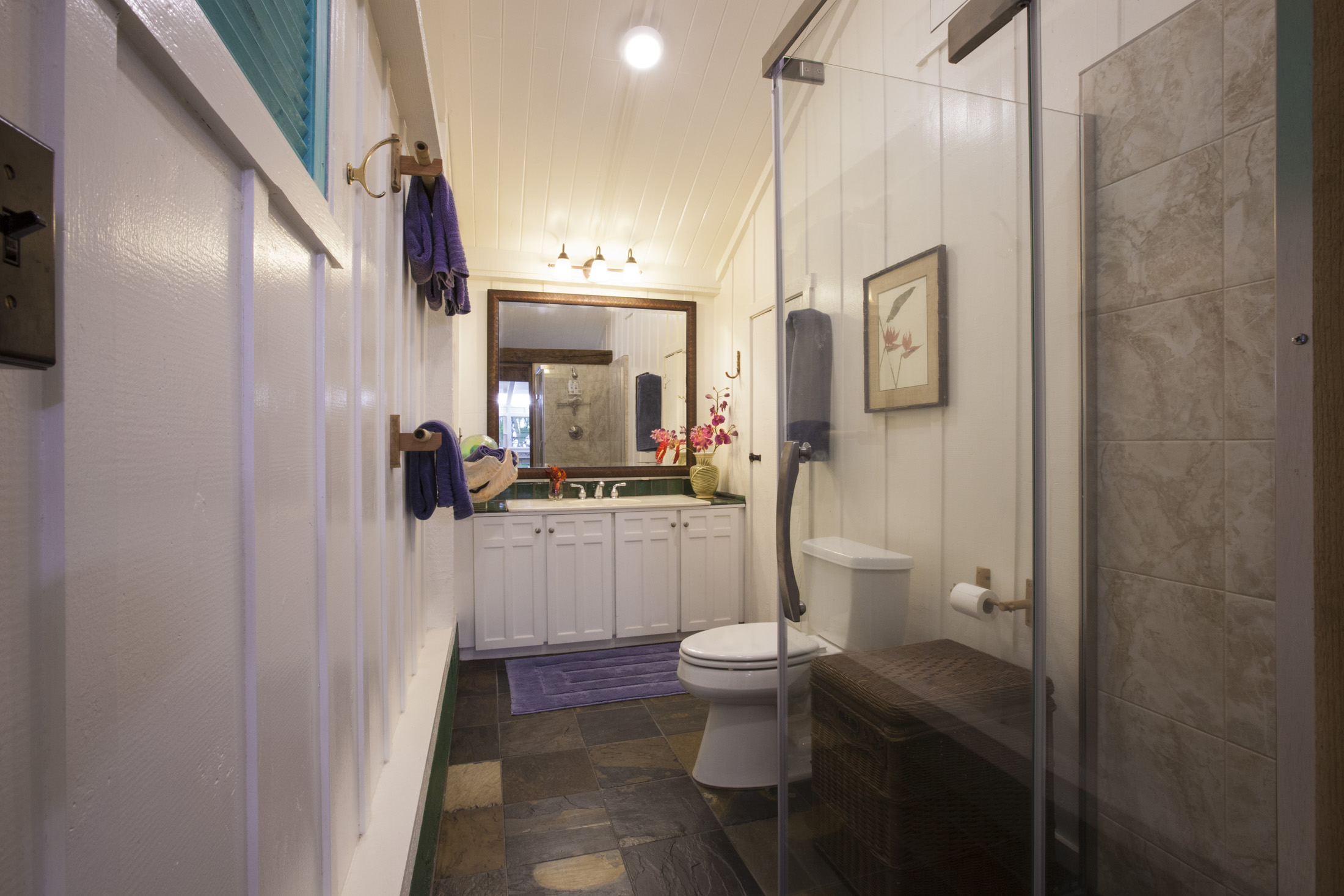 4261 Anini Road, Unit 2 Princeville, HI 96722 - Photo 19 of 28 a bathroom with a toilet sink and mirror