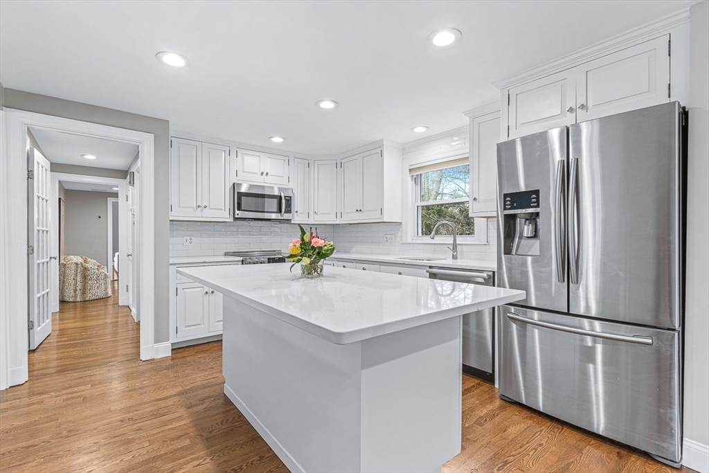 54 Homestead Park Needham, MA 02494 - Photo 2 of 26 a kitchen with a refrigerator a sink and cabinets