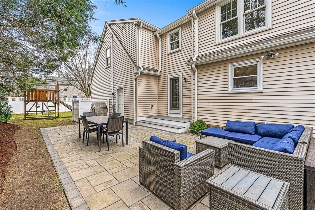 54 Homestead Park Needham, MA 02494 - Photo 24 of 26 a view of a chairs and table in the back yard of the house