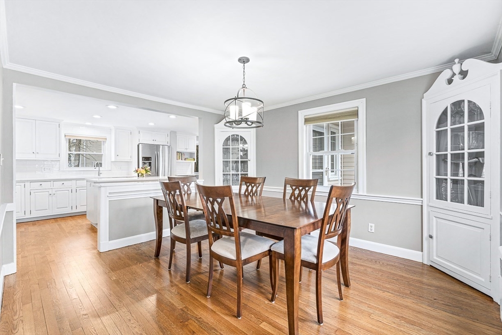 54 Homestead Park Needham, MA 02494 - Photo 5 of 26 a dining room with wooden floor a chandelier a wooden table and chairs