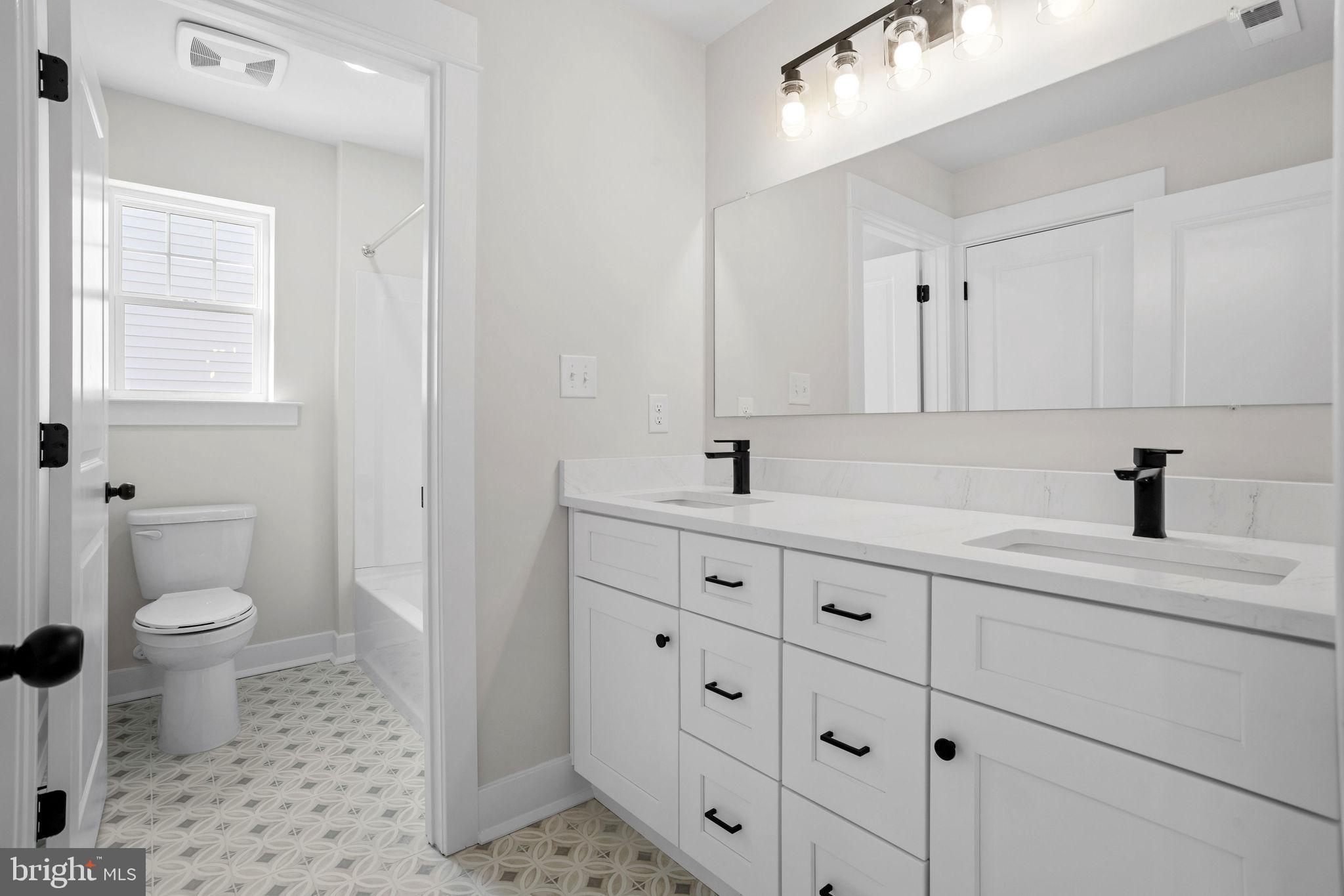 404 Midway Riverton, NJ 08077 - Photo 16 of 20 a bathroom with a sink a toilet and a mirror