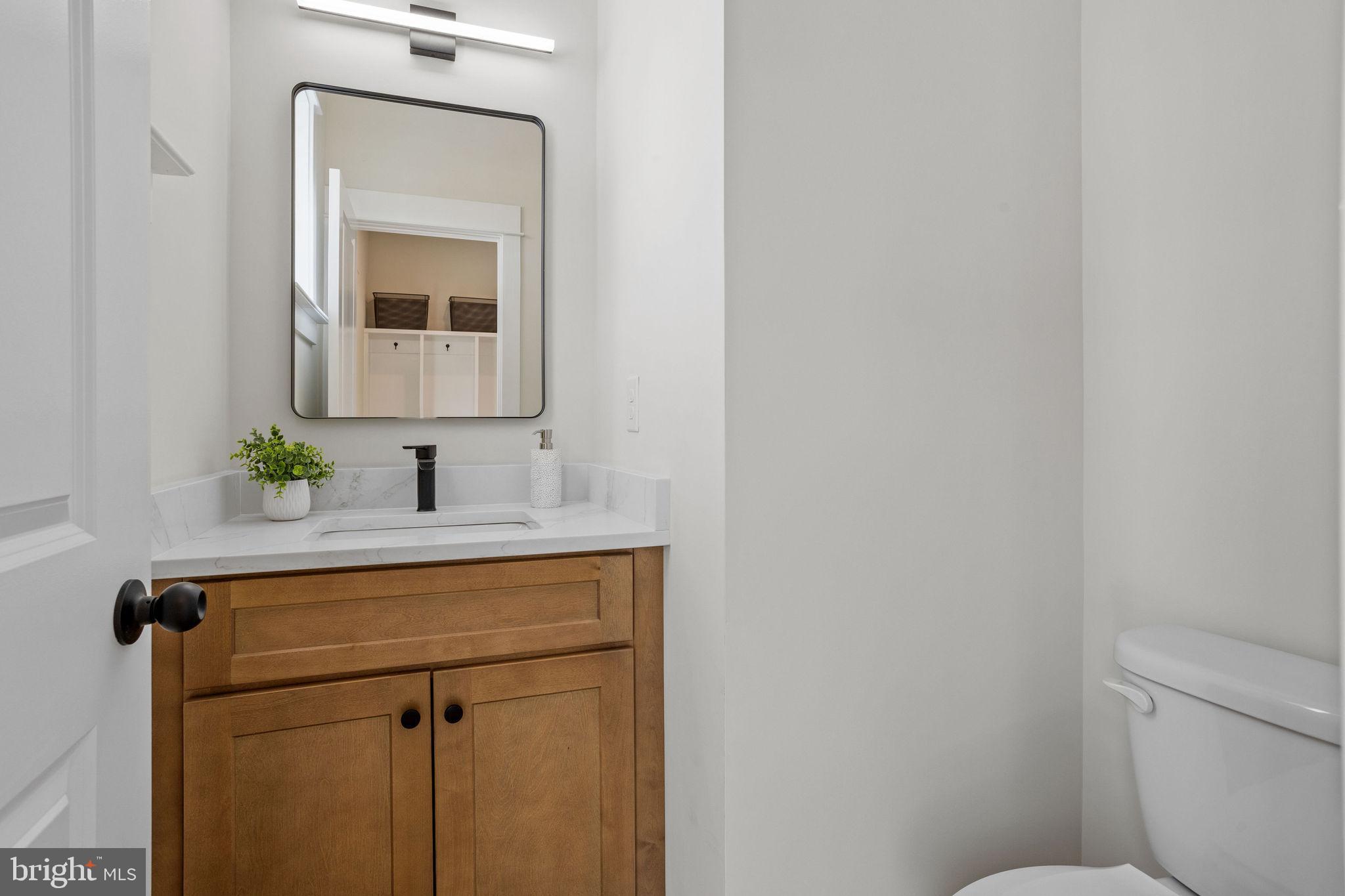404 Midway Riverton, NJ 08077 - Photo 9 of 20 a bathroom with a toilet sink and mirror
