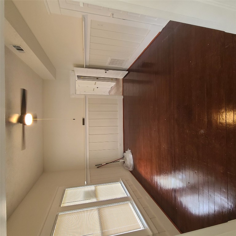 615 East Washington Street Giddings, TX 78942 - Photo 16 of 17 an empty room with wooden floor and windows