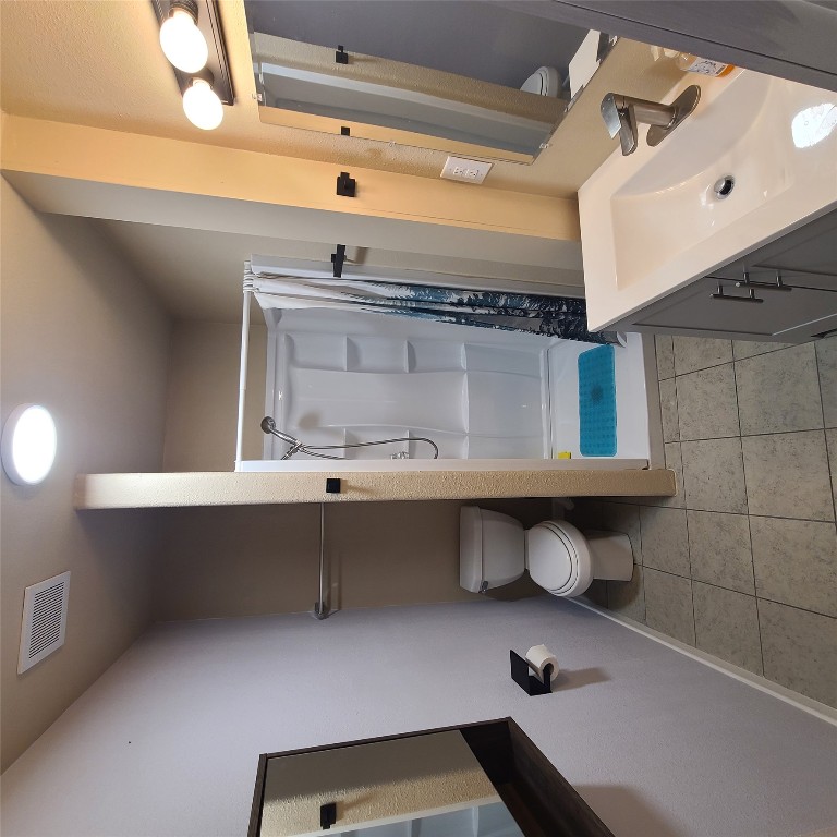 615 East Washington Street Giddings, TX 78942 - Photo 17 of 17 a bathroom with a sink a toilet and shower