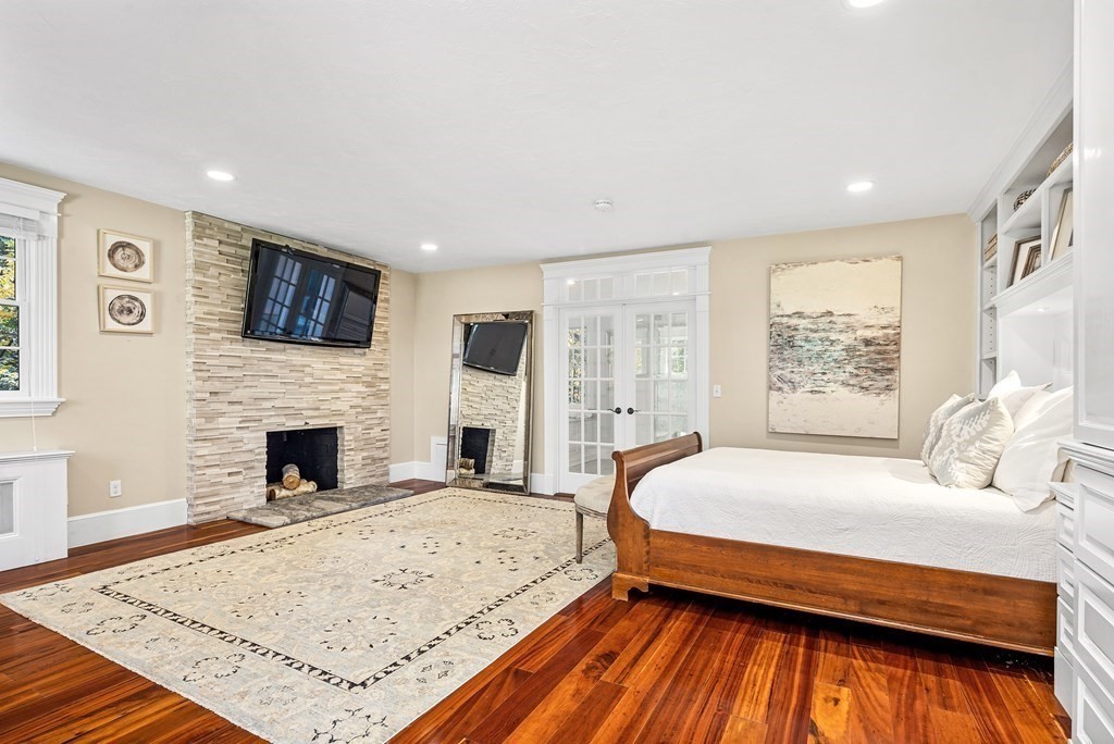 6 Peter Hobart Drive Hingham, MA 02043 - Photo 19 of 32 a bed sitting in a spacious bedroom next to a fireplace