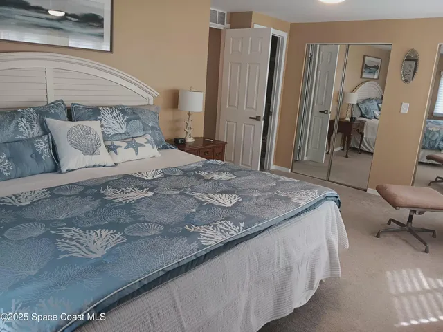 a bedroom with a bed a couch and dresser