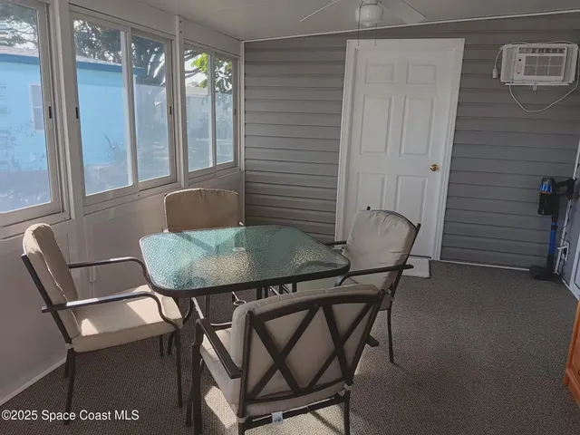 a view of a room with furniture and wooden floor